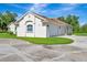 A three-car garage with adjacent home featuring arched window and concrete driveway at 5750 Saddle Oak Trl, Sarasota, FL 34241