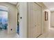 Hallway with tile flooring leads to bedroom and bathroom, with closet on right at 5750 Saddle Oak Trl, Sarasota, FL 34241