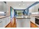 Bright kitchen boasts white cabinets, island, and natural light from the window at 5750 Saddle Oak Trl, Sarasota, FL 34241