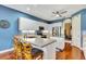 Kitchen with white cabinetry, stainless steel appliances, and an island with seating at 5750 Saddle Oak Trl, Sarasota, FL 34241