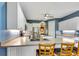 Eat-in kitchen with white cabinetry and a center island with barstool seating at 5750 Saddle Oak Trl, Sarasota, FL 34241