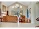Bright living room with vaulted ceilings, a fireplace, and large windows offering scenic views at 5750 Saddle Oak Trl, Sarasota, FL 34241