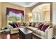Comfortable living room featuring a large sectional sofa, plush pillows, and natural light at 5750 Saddle Oak Trl, Sarasota, FL 34241