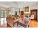 Inviting living room with hardwood floors, fireplace, and large windows at 5750 Saddle Oak Trl, Sarasota, FL 34241