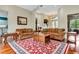 Spacious living room with hardwood floors, elegant rugs, and comfortable seating arrangements at 5750 Saddle Oak Trl, Sarasota, FL 34241