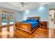 Spacious main bedroom with wood floors and French doors leading to pool at 5750 Saddle Oak Trl, Sarasota, FL 34241