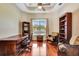 Office space featuring a wooden desk and chair, and bookcases at 5750 Saddle Oak Trl, Sarasota, FL 34241