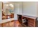 Office space featuring a wooden desk and chair, with a view to the home's interior and backyard at 5750 Saddle Oak Trl, Sarasota, FL 34241