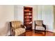 Sitting room featuring two chairs and a wooden bookshelf at 5750 Saddle Oak Trl, Sarasota, FL 34241