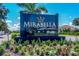 Elegant Mirabella community sign surrounded by colorful flowers and lush greenery welcomes residents and guests at 7108 Playa Bella Dr, Bradenton, FL 34209