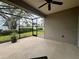Screened lanai with ceiling fan offers indoor-outdoor flow and beautiful views of manicured backyard and landscaping at 7108 Playa Bella Dr, Bradenton, FL 34209