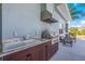 Well-equipped outdoor kitchen features a built-in grill and convenient sink for effortless al fresco dining at 7108 Playa Bella Dr, Bradenton, FL 34209