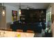 Bright living room featuring stylish pendant lighting, dark entertainment center, and comfortable seating at 7323 Great Egret Blvd, Sarasota, FL 34241
