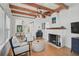 Cozy living room with exposed beam ceiling, hardwood floors, fireplace and an open floor plan at 820 Groveland Ave, Venice, FL 34285