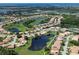 Aerial view of a residential community featuring ponds, golf areas, and well-maintained homes at 8503 Gateway Ct, Englewood, FL 34224