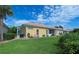 A well-manicured lawn highlights the backyard with a bench and enclosed patio space at 8503 Gateway Ct, Englewood, FL 34224