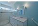 Stylish bathroom with double vanity, granite countertops, and a glass-enclosed shower at 8503 Gateway Ct, Englewood, FL 34224