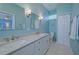 Elegant bathroom featuring double sinks, granite counters, and a separate toilet area at 8503 Gateway Ct, Englewood, FL 34224