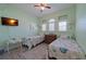 This is a cute guest bedroom with two twin beds, soft colors, and a flat screen TV at 8503 Gateway Ct, Englewood, FL 34224