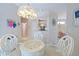 Light-filled breakfast nook with a glass table and decorative chandelier at 8503 Gateway Ct, Englewood, FL 34224