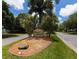 Stone Oyster Creek community sign surrounded by palm trees and lush green landscaping at 8503 Gateway Ct, Englewood, FL 34224