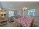 Inviting dining area with views to the living room and bright windows at 8503 Gateway Ct, Englewood, FL 34224