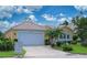 Charming single-story home featuring a well-manicured lawn and a two-car garage at 8503 Gateway Ct, Englewood, FL 34224