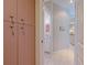 Hallway view with closet and pink cupboards leading to the bathroom and kitchen at 8503 Gateway Ct, Englewood, FL 34224