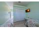 Hallway view with closet and flat screen TV leading to the bedrooms at 8503 Gateway Ct, Englewood, FL 34224