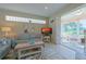Cozy living room featuring comfortable seating, a TV, and access to a sunroom at 8503 Gateway Ct, Englewood, FL 34224