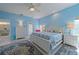 Bright main bedroom with king bed, ceiling fan, and access to an outdoor patio at 8503 Gateway Ct, Englewood, FL 34224