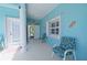 Inviting outdoor patio with comfortable seating and bright blue walls creating a relaxing space at 8503 Gateway Ct, Englewood, FL 34224