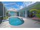 Beautiful backyard featuring a refreshing screened-in pool and an outdoor seating area at 8503 Gateway Ct, Englewood, FL 34224