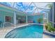 Inviting screened-in pool with clear water and a spacious patio area for relaxation at 8503 Gateway Ct, Englewood, FL 34224