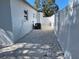 A gravel side yard with white fencing and exterior AC unit at 1041 S Tuttle Ave, Sarasota, FL 34237