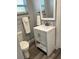 Bathroom featuring a modern vanity, framed mirror and wood-style flooring, providing a clean aesthetic at 1041 S Tuttle Ave, Sarasota, FL 34237