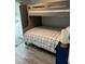 This bedroom features a bunk bed, new floors, and neutral paint at 1041 S Tuttle Ave, Sarasota, FL 34237
