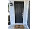 Stylish front door with a welcome mat, and a textured wall create a warm and inviting entry at 1041 S Tuttle Ave, Sarasota, FL 34237