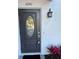 This home features an elegant front door with decorative glass and a stylish outdoor lantern, offering a welcoming entrance at 1041 S Tuttle Ave, Sarasota, FL 34237