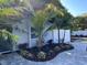 Landscaped yard with tropical plants and updated brick pavers at 1041 S Tuttle Ave, Sarasota, FL 34237