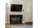 Comfortable living area equipped with a wall-mounted TV, a table with stools, and laminate flooring at 1041 S Tuttle Ave, Sarasota, FL 34237
