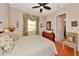 Bedroom featuring a tropical style, ceiling fan, and wood floors at 10912 Big Bass Pl, Bradenton, FL 34212