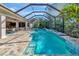 Inviting screened-in pool area with hot tub and lush tropical landscaping, perfect for relaxation and entertaining at 10912 Big Bass Pl, Bradenton, FL 34212