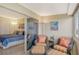Cozy sitting area on a sunny balcony, leading to a bedroom with a comfortable blue bedspread at 1125 W Peppertree Dr # 706, Sarasota, FL 34242