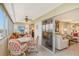 Enclosed sunroom with desk, seating and sweeping views of the city at 1125 W Peppertree Dr # 706, Sarasota, FL 34242