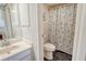 Classic bathroom with a vanity and toilet, complemented by a shower with a blue and white floral curtain at 1125 W Peppertree Dr # 706, Sarasota, FL 34242