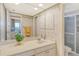 Well-lit bathroom featuring a large mirror, vanity, and walk-in shower at 1125 W Peppertree Dr # 706, Sarasota, FL 34242