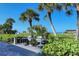Outdoor community grills and tables with lush landscaping near white sand beach at 1125 W Peppertree Dr # 706, Sarasota, FL 34242