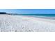 Wide view of white sand beach near turquoise water with people in the distance at 1125 W Peppertree Dr # 706, Sarasota, FL 34242