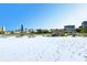 Beautiful beach featuring white sand, picnic tables, and clear blue skies, perfect for relaxation at 1125 W Peppertree Dr # 706, Sarasota, FL 34242